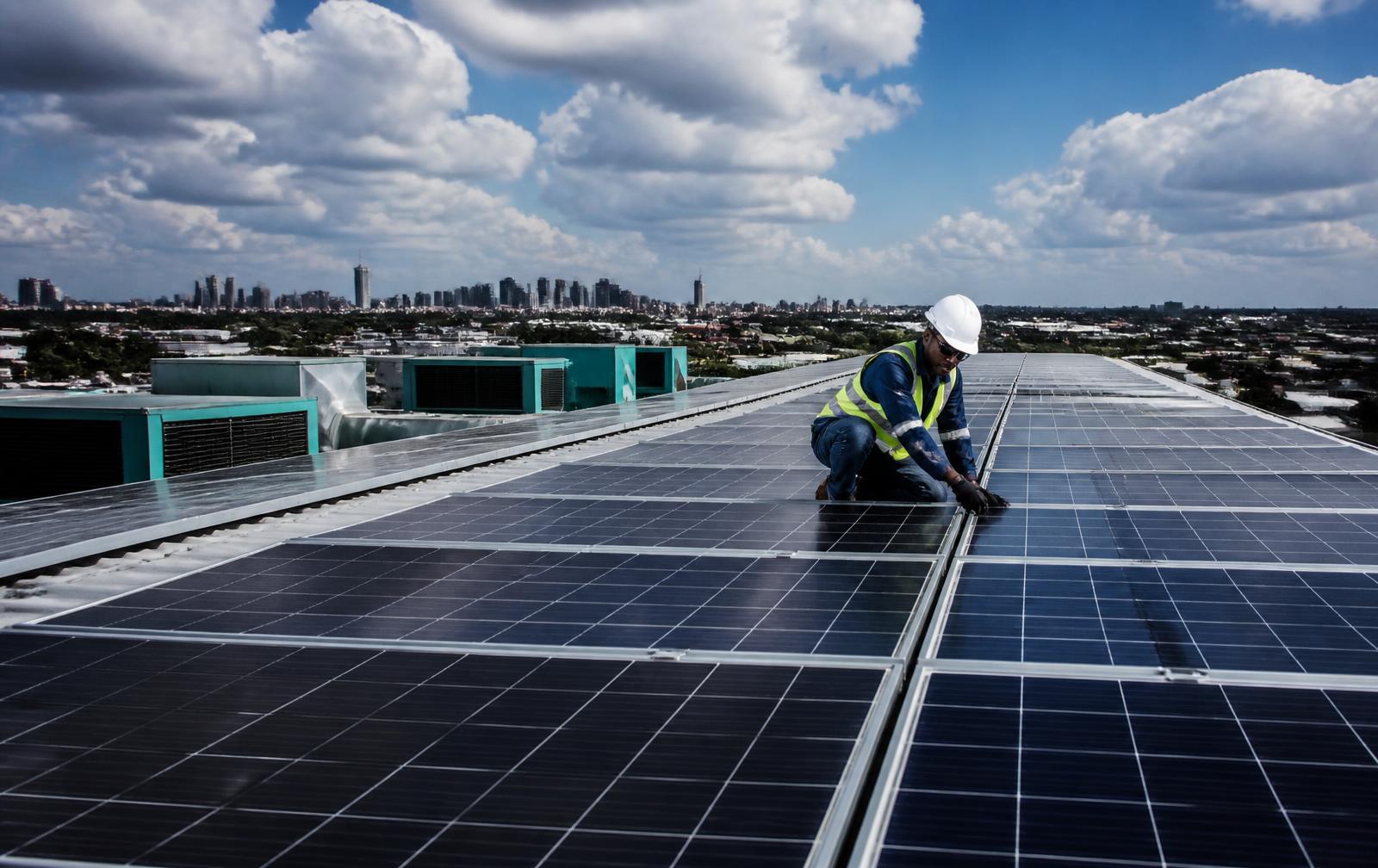Technician inspecting a commercial solar installation